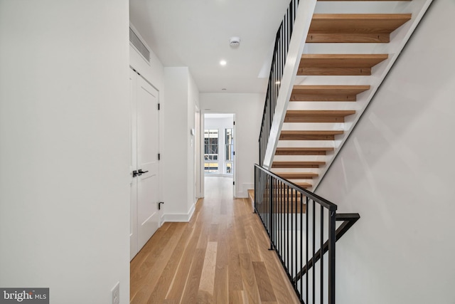 corridor with light hardwood / wood-style floors