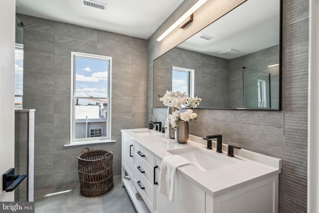 bathroom featuring tile walls, vanity, and plenty of natural light