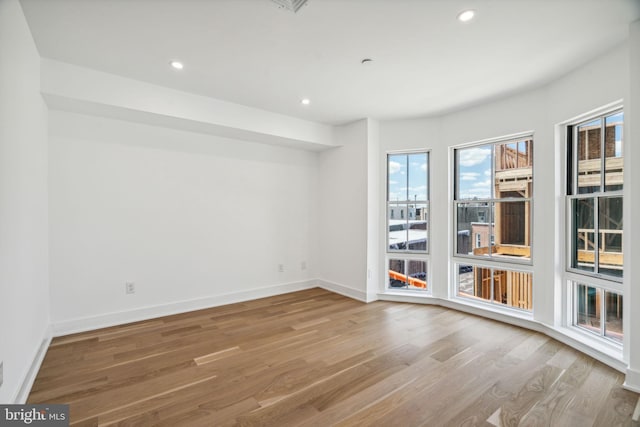 unfurnished room with light hardwood / wood-style flooring