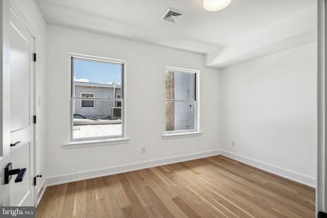 unfurnished room with light hardwood / wood-style floors