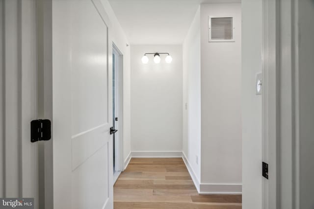 corridor with light hardwood / wood-style floors