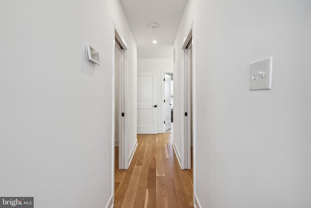 corridor with light wood-type flooring