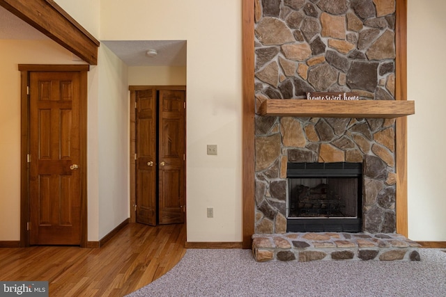 interior space featuring hardwood / wood-style flooring and a stone fireplace