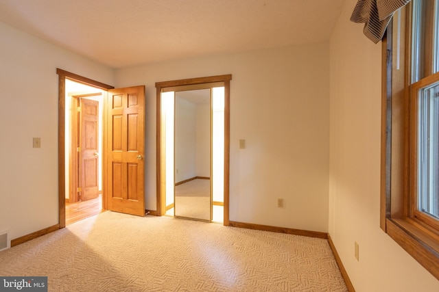 unfurnished bedroom with light carpet