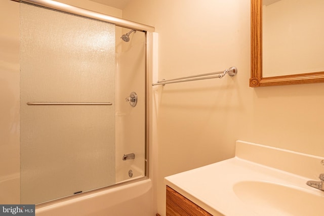 bathroom featuring vanity and enclosed tub / shower combo