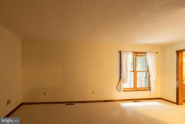 unfurnished room with a textured ceiling