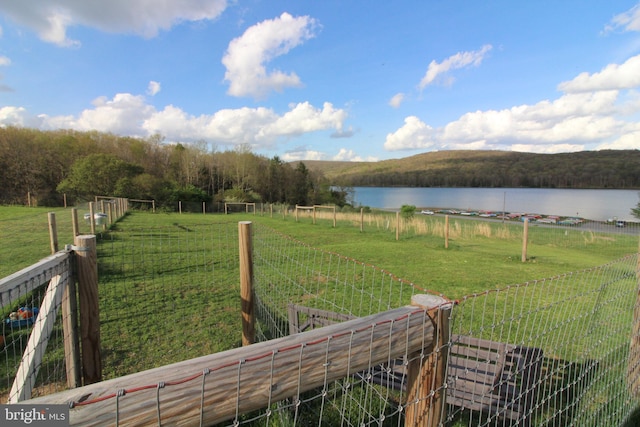 view of yard with a rural view and a water view