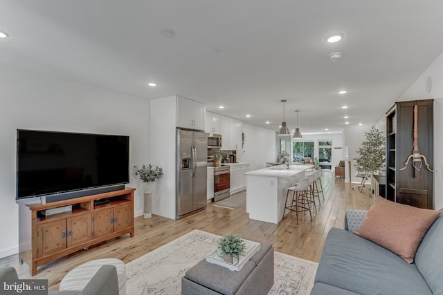 living room with light hardwood / wood-style flooring