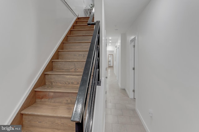 staircase with tile patterned floors