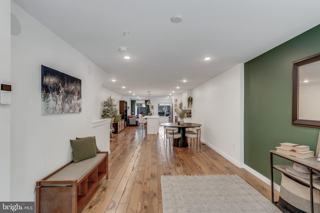 hallway with light hardwood / wood-style floors