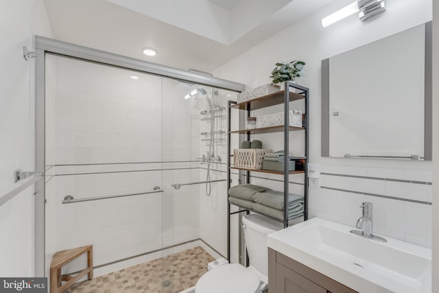 bathroom featuring vanity, toilet, and walk in shower