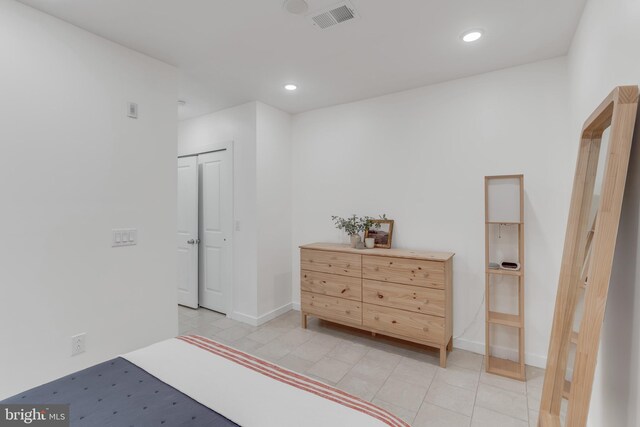 tiled bedroom featuring a closet