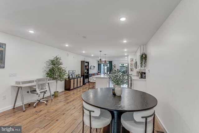 dining area with light hardwood / wood-style floors