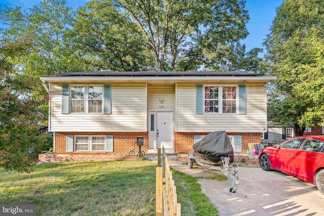 5120 Crittenden St, Hyattsville, MD 20781 - split foyer home with solar panels, a front lawn, and brick siding
