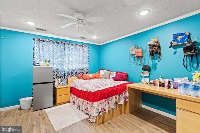 5120 Crittenden St, Hyattsville, MD 20781 - bedroom with freestanding refrigerator, a textured ceiling, ornamental molding, wood finished floors, and ceiling fan