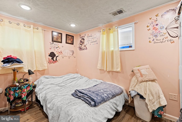 5120 Crittenden St, Hyattsville, MD 20781 - bedroom with wood finished floors, ornamental molding, a textured ceiling, recessed lighting, and baseboards