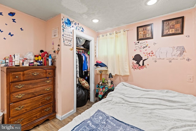 5120 Crittenden St, Hyattsville, MD 20781 - bedroom featuring light wood-type flooring, a textured ceiling, a closet, baseboards, and recessed lighting