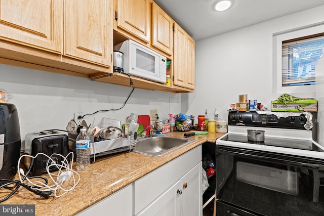 5120 Crittenden St, Hyattsville, MD 20781 - kitchen with range with electric cooktop, white microwave, a sink, light countertops, and light brown cabinets