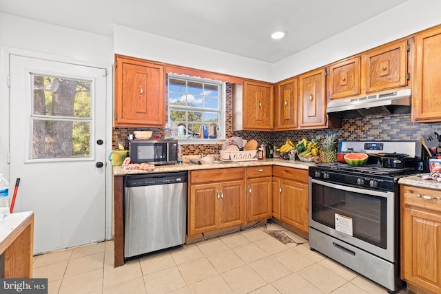 5120 Crittenden St, Hyattsville, MD 20781 - kitchen featuring stainless steel appliances, under cabinet range hood, backsplash, and brown cabinets