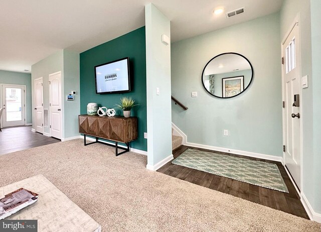 entryway with dark hardwood / wood-style flooring