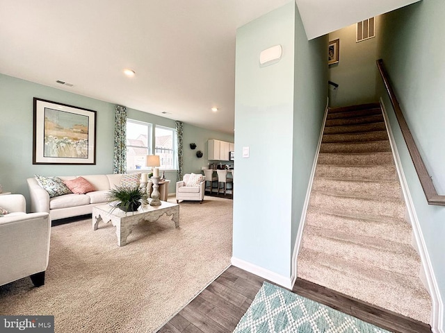 staircase with hardwood / wood-style flooring