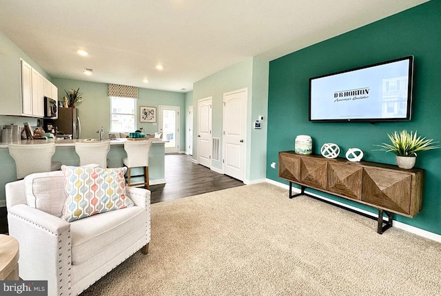 living room with dark colored carpet