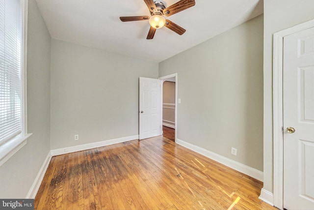 empty room with light hardwood / wood-style floors and ceiling fan