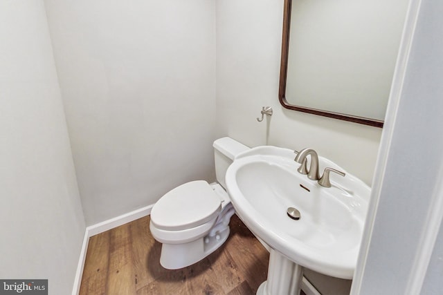 bathroom featuring sink, hardwood / wood-style floors, and toilet