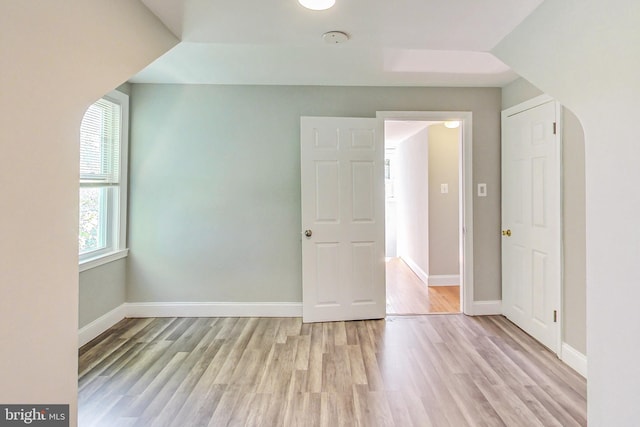 additional living space with light hardwood / wood-style floors