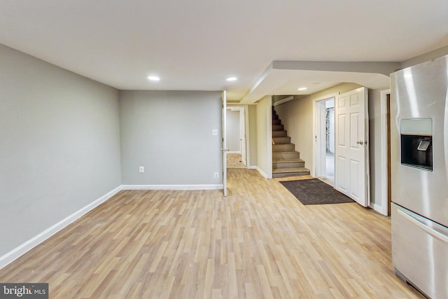 interior space with light wood-type flooring and stainless steel fridge with ice dispenser