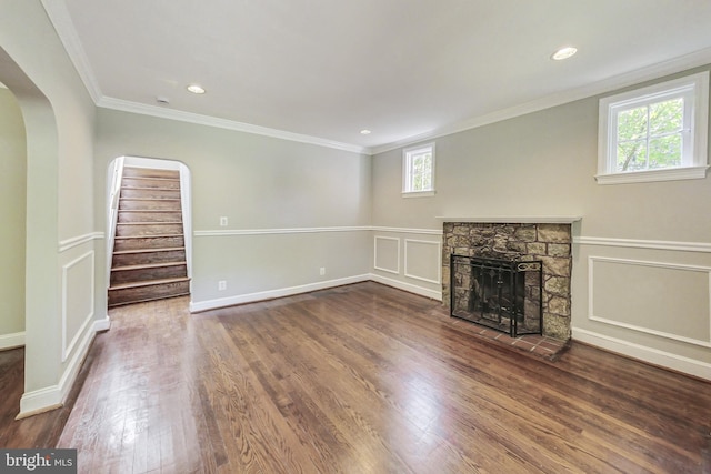 unfurnished living room with hardwood / wood-style flooring, a fireplace, and a healthy amount of sunlight