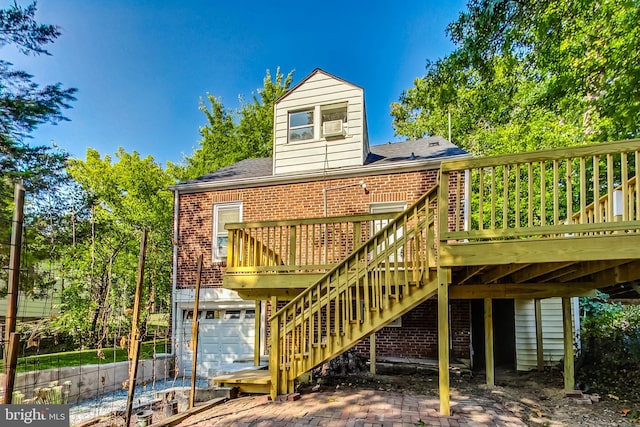 back of house featuring a garage and a deck