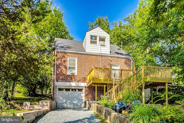 view of front of house featuring a garage and a wooden deck