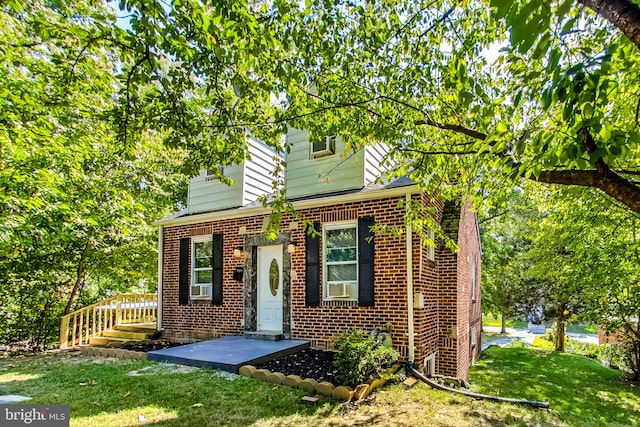 view of front of home with cooling unit and a front lawn