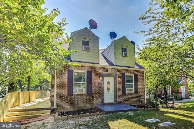 view of front of home with cooling unit and a front lawn