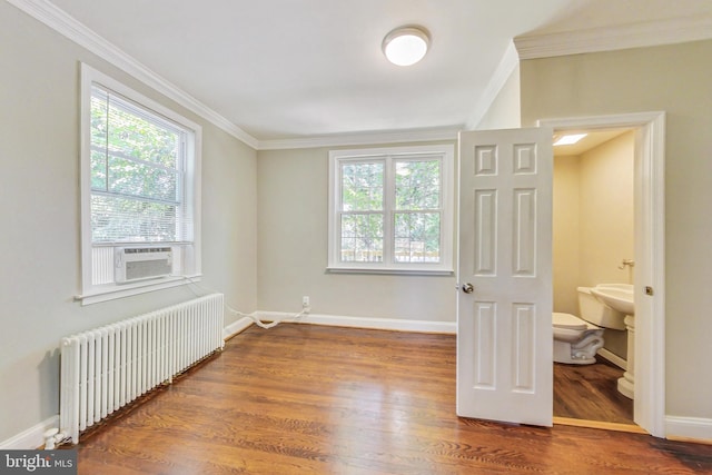 bedroom with wood-type flooring, ornamental molding, radiator heating unit, and cooling unit