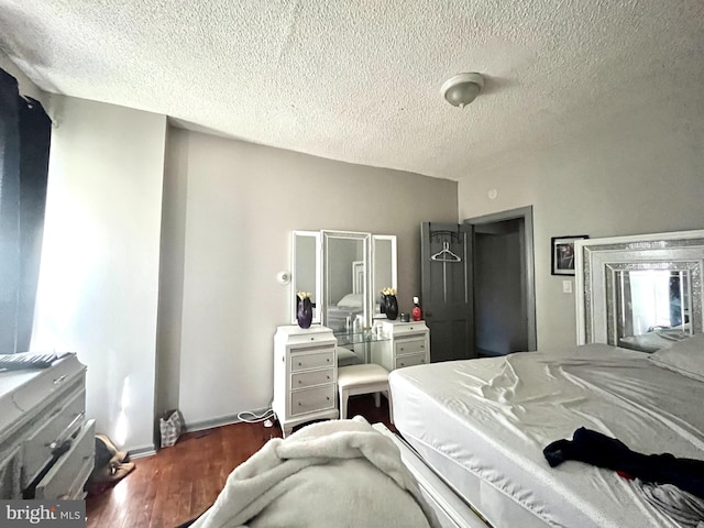 bedroom featuring a textured ceiling and hardwood / wood-style floors