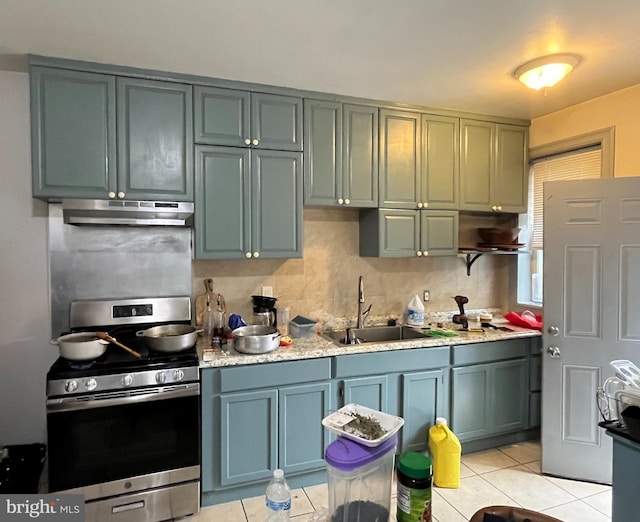 kitchen featuring light tile patterned floors, sink, exhaust hood, stainless steel range oven, and decorative backsplash