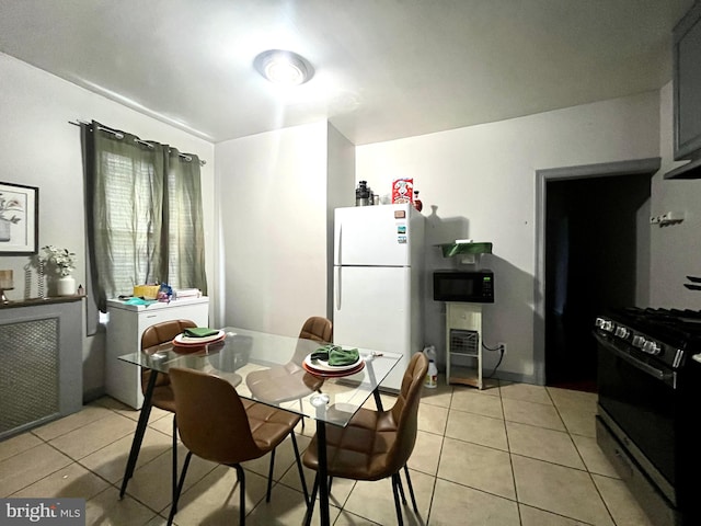 dining area featuring light tile patterned floors