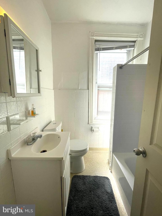 full bathroom with vanity, toilet, decorative backsplash, and shower / bathtub combination