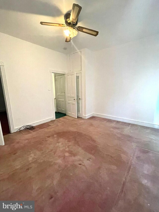 unfurnished bedroom with ceiling fan and carpet flooring