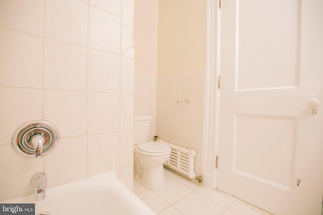 bathroom featuring tile patterned flooring, toilet, tile walls, radiator heating unit, and a tub