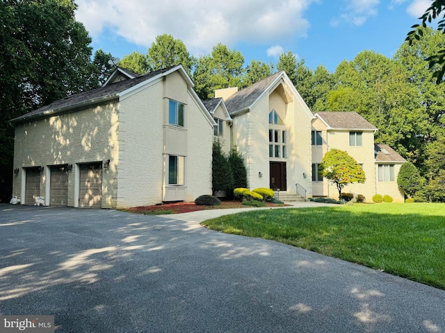 front of property with a garage and a front yard