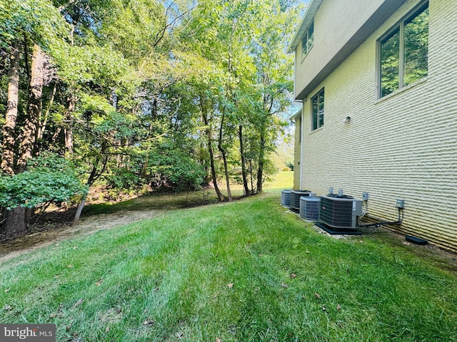 view of yard with central air condition unit