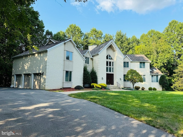 view of front of property with a garage and a front yard