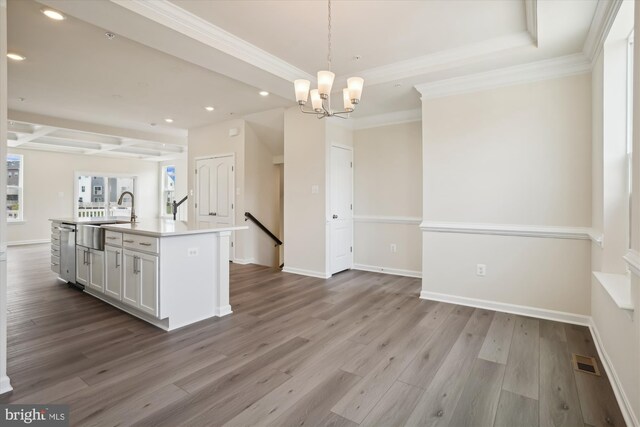 bedroom featuring light wood-type flooring, a walk in closet, an inviting chandelier, and a closet