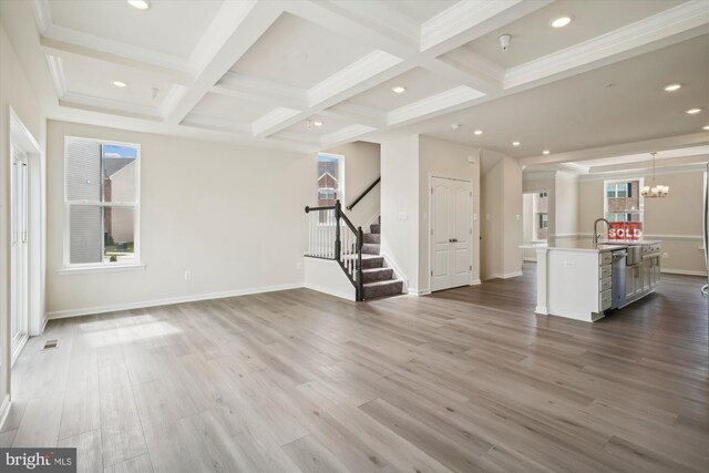 living room featuring beam ceiling, coffered ceiling, and light wood-type flooring