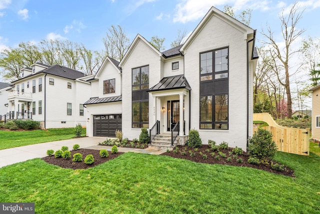 modern inspired farmhouse featuring a front yard and a garage