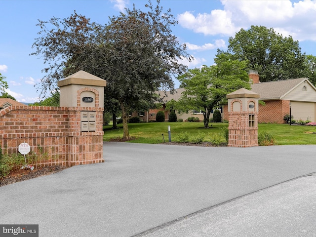 view of gate featuring a yard