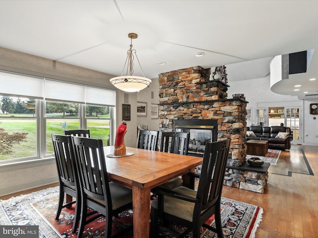 dining space featuring light hardwood / wood-style flooring and a fireplace